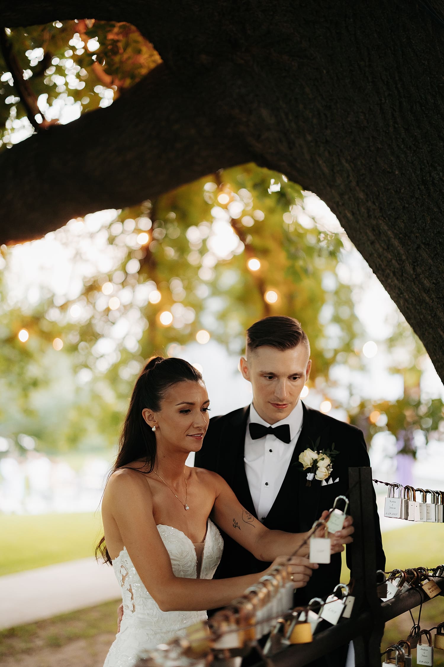 man and woman add lock to string at venue for Summer garden party