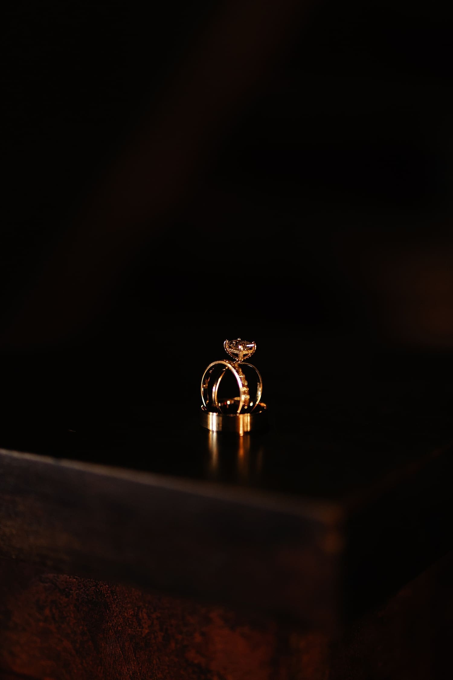 two rings stacked on table after learning 5 things to ask your wedding photographer