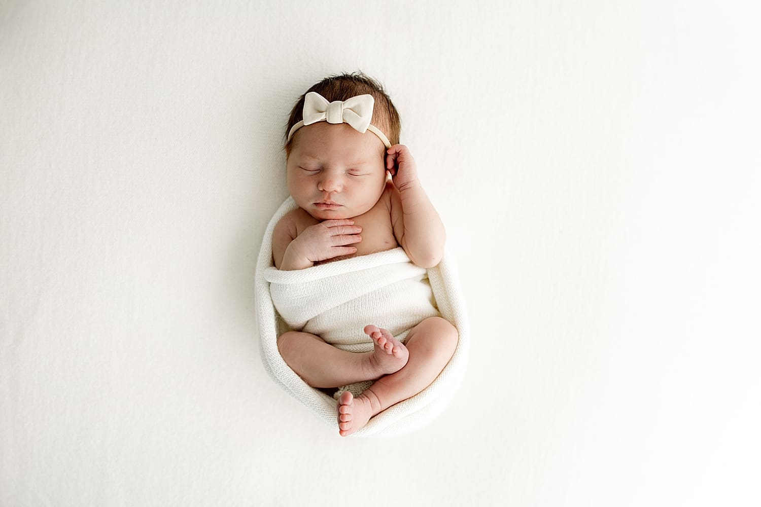infant wrapped in cloth by Rose and Oak Photography