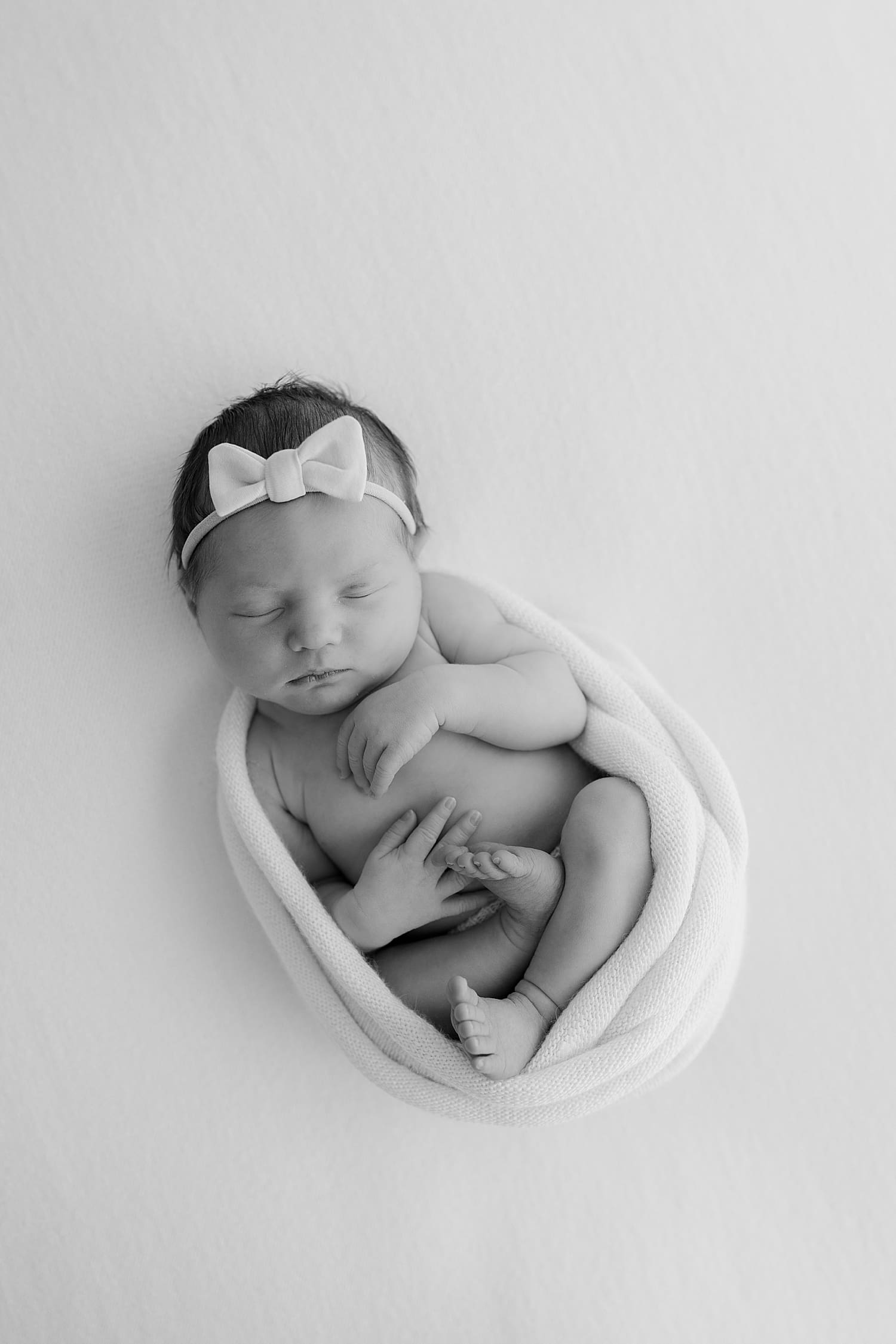 new infant swaddled in cloth by Rose and Oak Photography