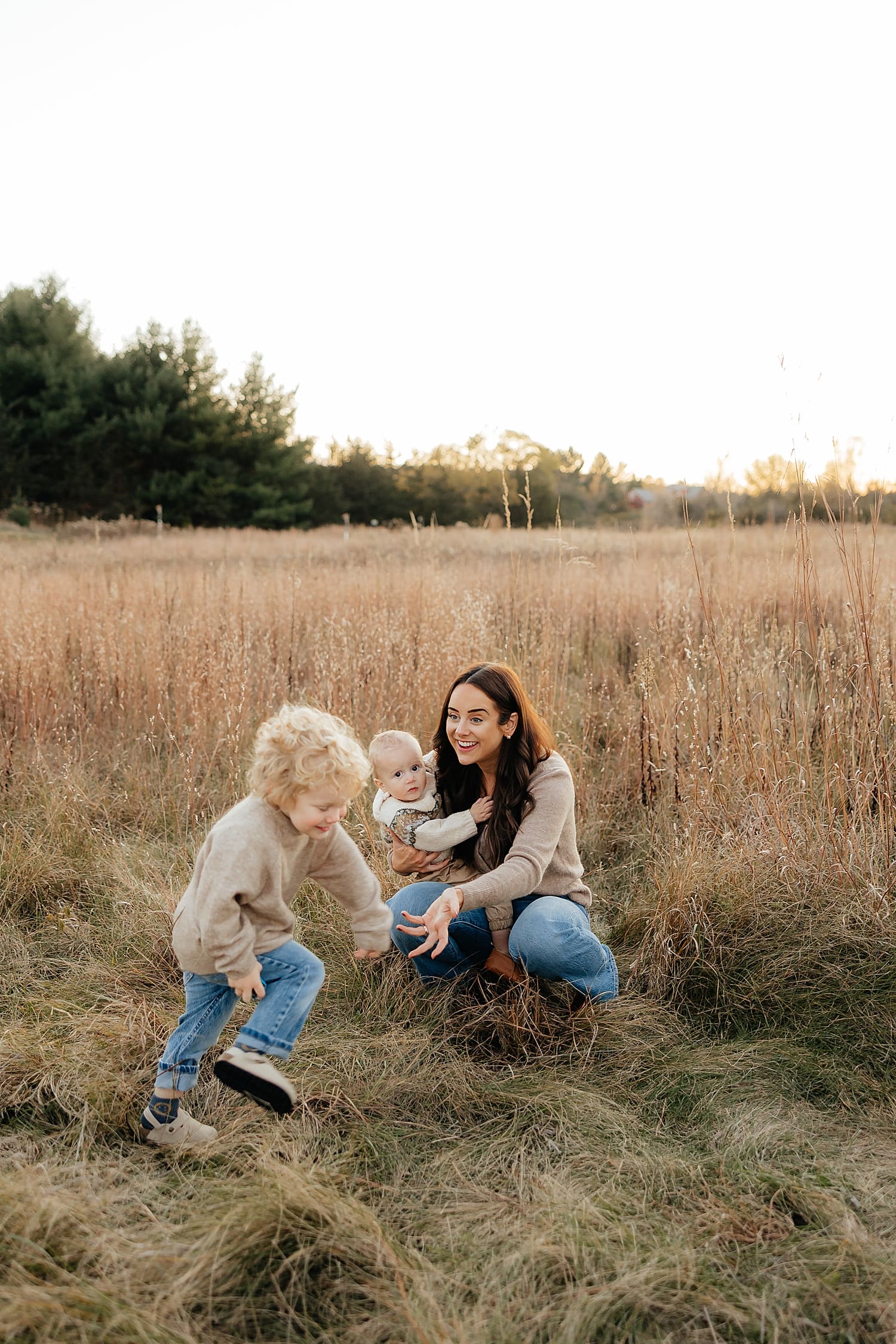 mom holds toddler for documentary style family session