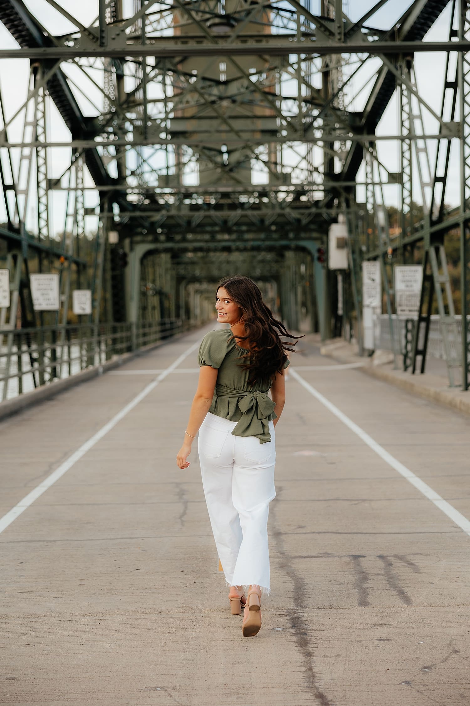model walks down bridge street by Rose and Oak Photography