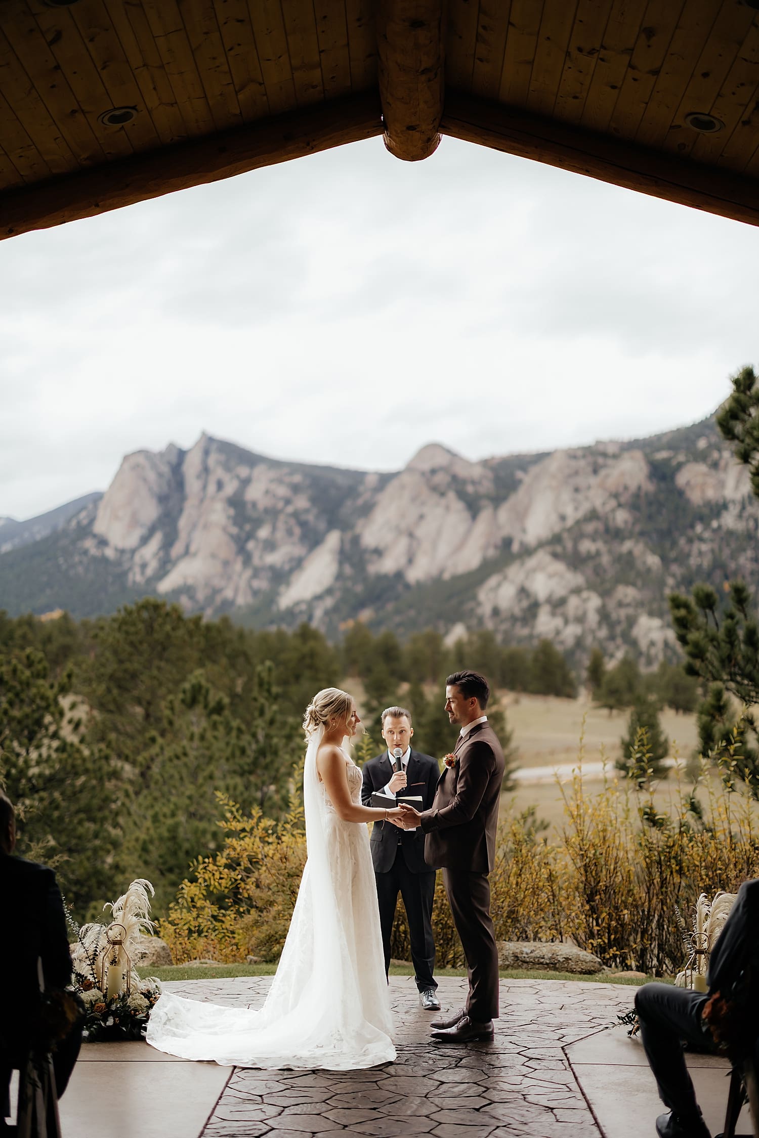 couple get married at outdoor alter in front of colorado mountains by Rose and Oak Photography