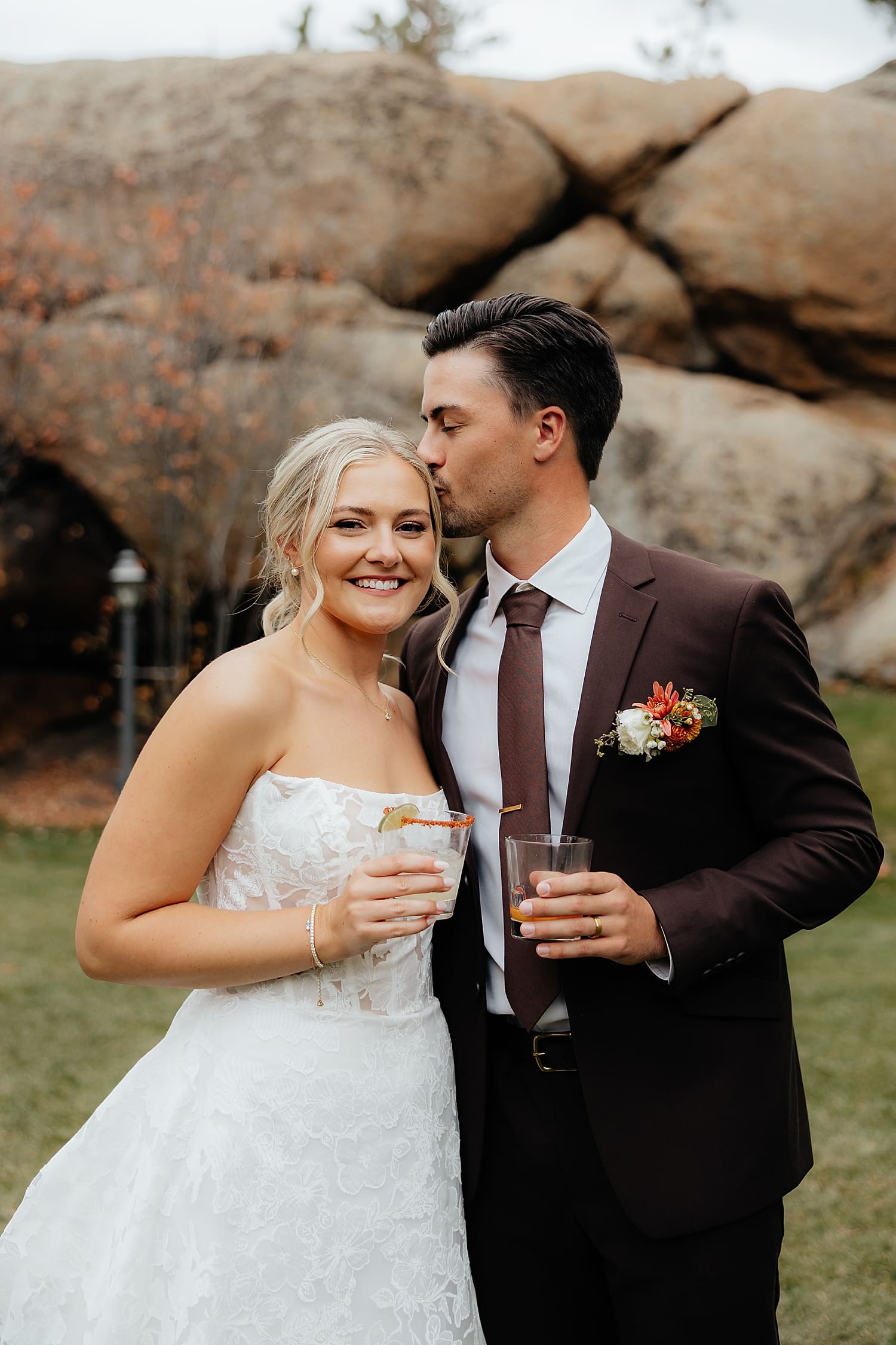 newlyweds hold cocktails at reception for laid-back celebration at Estes Park