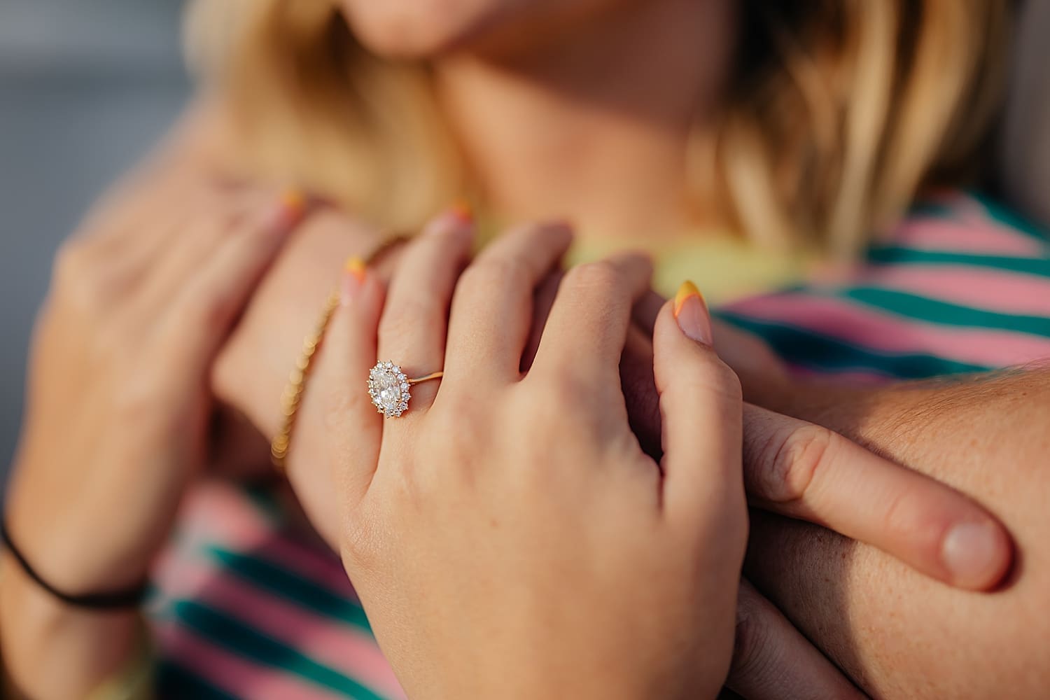 sparkling diamond halo ring on new fiance's finger by Rose and Oak Photography