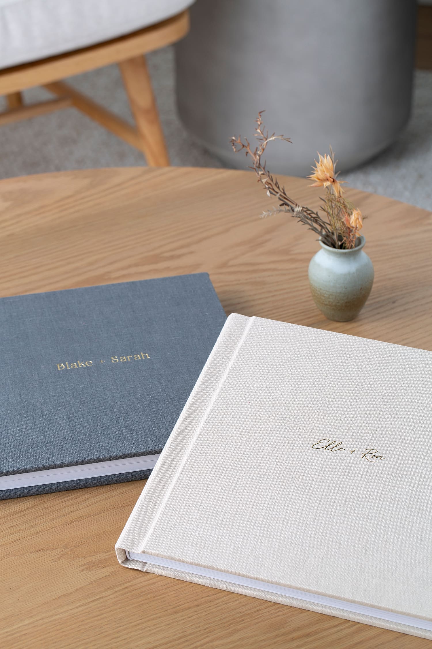 two linen albums on wooden coffee table at Rose and Oak photography studio