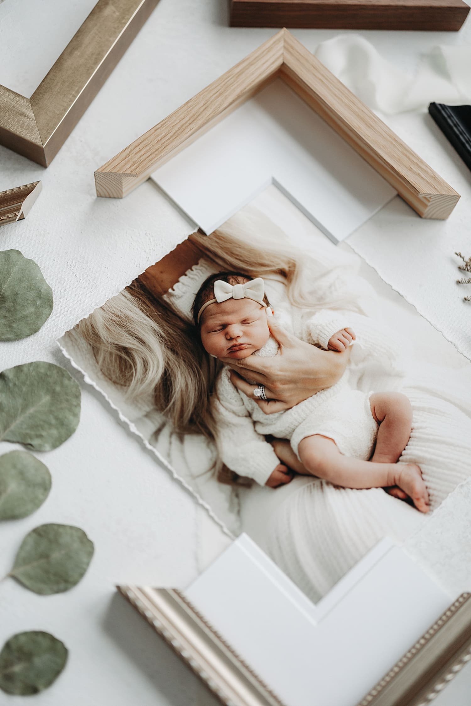 physical print of mother holding newborn on table for timeless artwork
